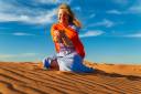 girl-plays-with-sand-sahara-desert-erg-chebbi-merzouga-morocco